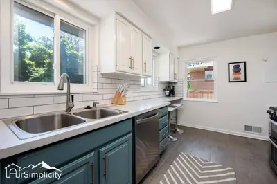 a kitchen with a sink and a window at Peaceful home w fire pit & game room in Denver