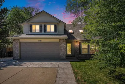 a house with a garage in front of it at Suburban Sanctuary Sauna Tub Large Yard in Westminster