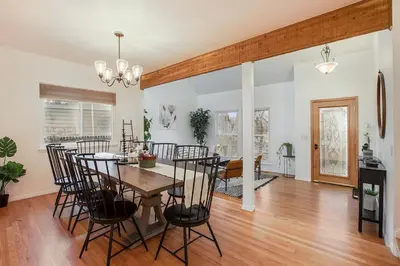 a dining room and living room with a table and chairs at Suburban Sanctuary Sauna Tub Large Yard in Westminster
