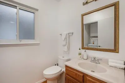 a bathroom with a sink and a toilet and a mirror at Suburban Sanctuary Sauna Tub Large Yard in Westminster