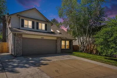a house with a garage and a tree at Suburban Sanctuary Sauna Tub Large Yard in Westminster