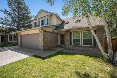 a brick house with a garage and a tree at Suburban Sanctuary Sauna Tub Large Yard in Westminster