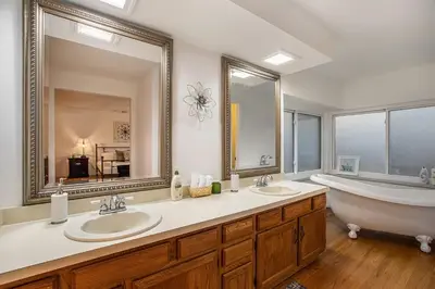 a bathroom with two sinks and a tub and a large mirror at Suburban Sanctuary Sauna Tub Large Yard in Westminster