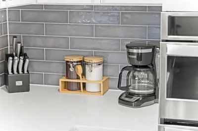 a kitchen counter with a coffee maker on a counter at The Denver Den Game Room Foosball in Westminster