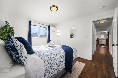 a white bedroom with a bed and a window at The Denver Den Game Room Foosball in Westminster