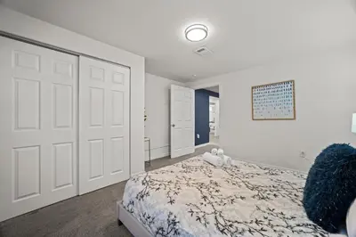 a bedroom with a bed and a large white door at The Denver Den Game Room Foosball in Westminster