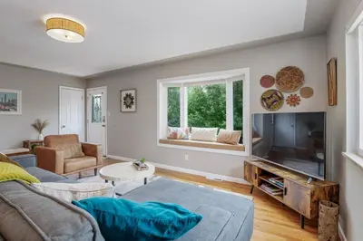 a living room with a couch and a tv at Spacious home w hot tub & fire pit in Denver
