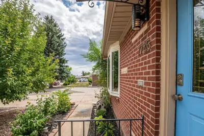 a brick house with a blue door and a sidewalk at Spacious home w hot tub & fire pit in Denver