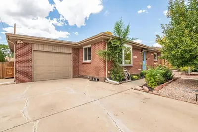 a brick house with a garage at Spacious home w hot tub & fire pit in Denver