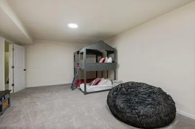 a bedroom with a bed in the corner of a room at Fire Pit Funhouse 2 Master Suites Game Rm in Westminster