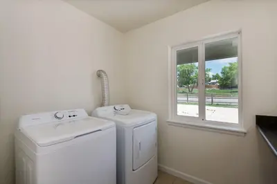 a laundry room with a washer and dryer and a window at Fire Pit Funhouse 2 Master Suites Game Rm in Westminster