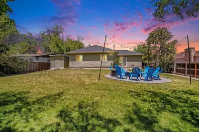 a yard with blue chairs and a house at Fire Pit Funhouse 2 Master Suites Game Rm in Westminster