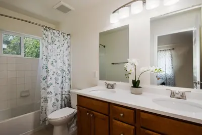 a bathroom with a sink and a toilet and a mirror at Fire Pit Funhouse 2 Master Suites Game Rm in Westminster