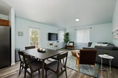a living room with a table and a couch at Fire Pit Funhouse 2 Master Suites Game Rm in Westminster