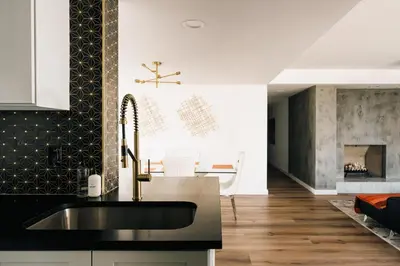 a kitchen with a sink and a fireplace at Deluxe Larimer Square Retreat - Walk Everywhere! in Denver