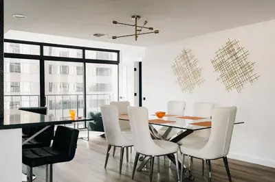 a dining room with a table and white chairs at Deluxe Larimer Square Retreat - Walk Everywhere! in Denver