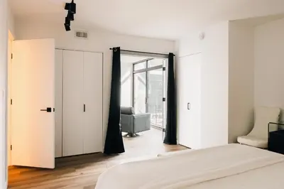 a bedroom with a bed and a sliding door at Deluxe Larimer Square Retreat - Walk Everywhere! in Denver