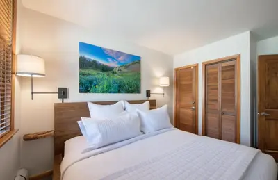 a bedroom with a large white bed with white pillows at Premium Unit 2308 - 1Br - Zephyr Mountain Lodge condo in Winter Park