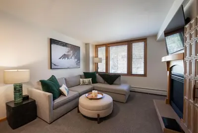 a living room with a couch and a tv at Premium Unit 2308 - 1Br - Zephyr Mountain Lodge condo in Winter Park