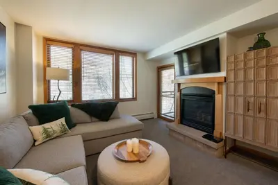 a living room with a couch and a fireplace at Premium Unit 2308 - 1Br - Zephyr Mountain Lodge condo in Winter Park
