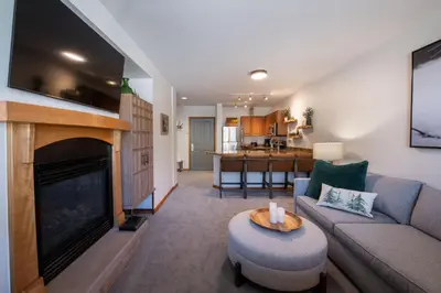 a living room with a couch and a fireplace at Premium Unit 2308 - 1Br - Zephyr Mountain Lodge condo in Winter Park