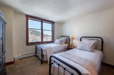 a bedroom with two beds and a window at Premium Unit 2801 - Zephyr Mountain Lodge condo in Winter Park