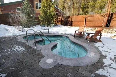 a small swimming pool with snow on the ground at 8712 Ski Tip Townhomes townhouse in Keystone