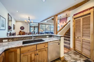 a kitchen with a sink and a staircase at 8712 Ski Tip Townhomes townhouse in Keystone
