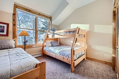 a bedroom with two bunk beds and a window at 8712 Ski Tip Townhomes townhouse in Keystone