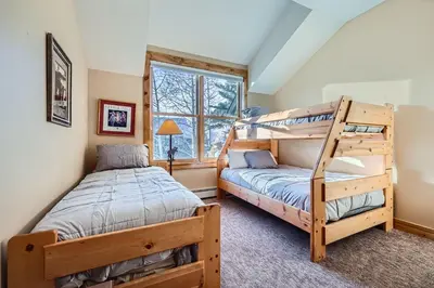 a bedroom with two bunk beds and a twin bed at 8712 Ski Tip Townhomes townhouse in Keystone