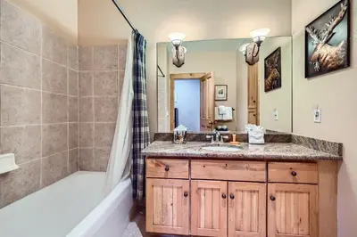 a bathroom with a sink and a tub and a shower at 8712 Ski Tip Townhomes townhouse in Keystone