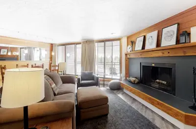 a living room with a couch and a fireplace at 1765 Montezuma condo in Keystone