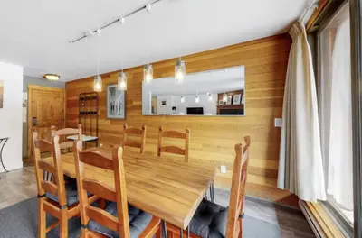 a dining room with a wooden table and chairs at 1765 Montezuma condo in Keystone