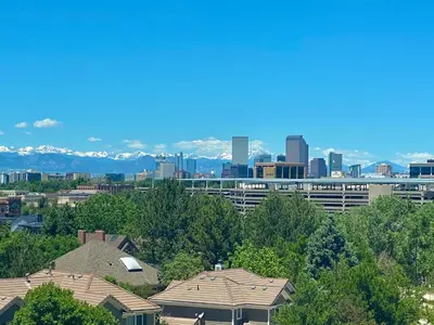 a view of a city with buildings and trees at Cherry Creek Condo in Denver