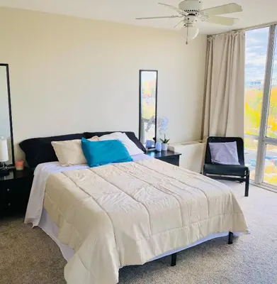 a bedroom with a bed and a ceiling fan at Cherry Creek Condo in Denver