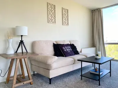 a living room with a couch and a table at Cherry Creek Condo in Denver