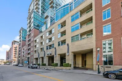 an empty street in front of a large brick building at 1700 Bassett, Unit 711 in Denver