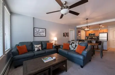 a living room with a couch and a table at Premium Unit 4285 Fraser Crossing Founders Pointe condo in Winter Park
