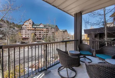 a balcony with chairs and a view of a building at Premium Unit 4285 Fraser Crossing Founders Pointe condo in Winter Park