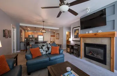 a living room with a fireplace and a flat screen tv at Premium Unit 4285 Fraser Crossing Founders Pointe condo in Winter Park