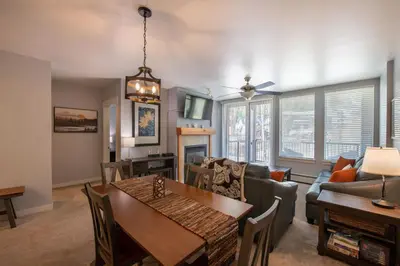 a dining room and living room with a dining table at Premium Unit 4285 Fraser Crossing Founders Pointe condo in Winter Park