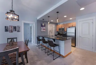 a kitchen and dining room with a table and a refrigerator at Premium Unit 4285 Fraser Crossing Founders Pointe condo in Winter Park