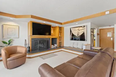 a living room with a couch and a fireplace at Decatur 1785 in Keystone