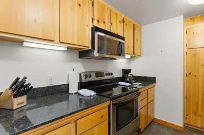 a kitchen with wooden cabinets and a stove top oven at Decatur 1785 in Keystone