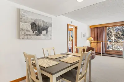 a dining room with a wooden table and chairs at Decatur 1785 in Keystone
