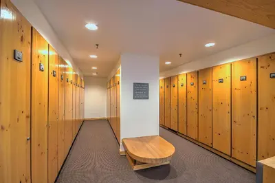 a row of wooden lockers in a hallway with a bench at Decatur 1785 in Keystone