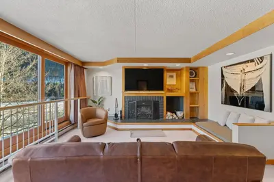 a living room with a couch and a fireplace at Decatur 1785 in Keystone
