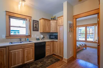 a kitchen with wooden cabinets and a sink at Riverbend views ten feet away in Granby