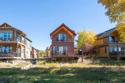 a row of houses with balconies on a lawn at Riverbend views ten feet away in Granby