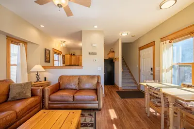 a living room with a couch and a table at Riverbend views ten feet away in Granby